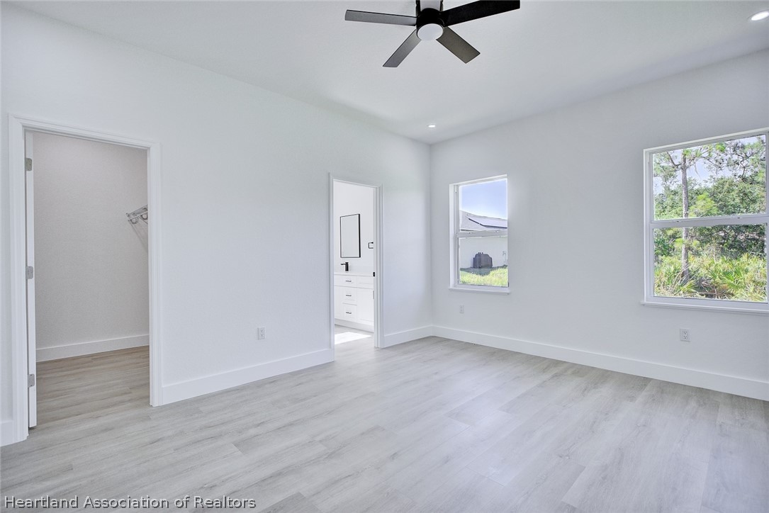 4307 Talbot Street Sebring, FL 33872 - Photo 8 of 19 a view of room with hardwood floor and window