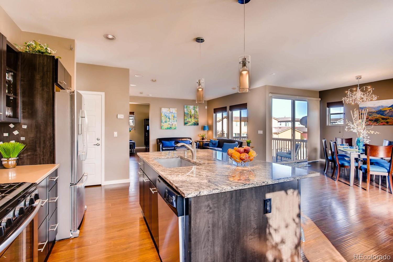 3435 Cranston Circle Highlands Ranch, CO 80126 - Photo 11 of 40 a open kitchen with stainless steel appliances granite countertop a refrigerator a stove and a sink