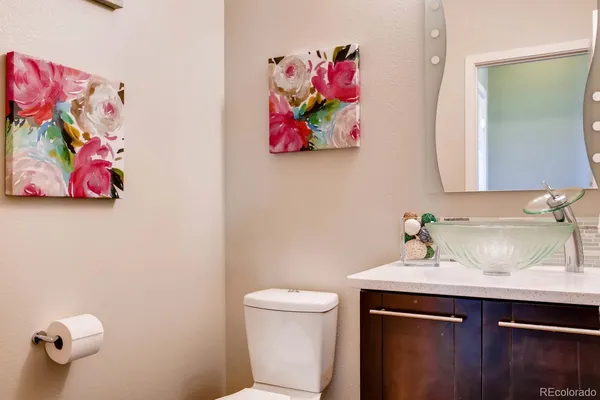 a bathroom with a sink mirror and vanity