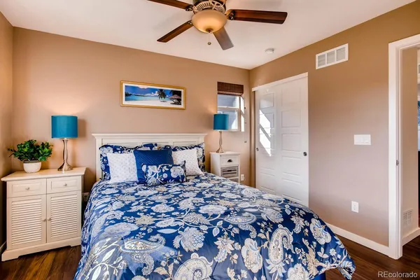a bedroom with a large bed and a chandelier