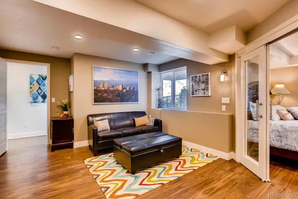a living room with furniture and wooden floor