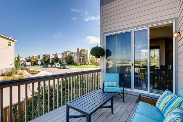 a view of a balcony with wooden floor and outdoor seating