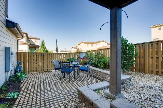 a view of a patio with a table and chairs