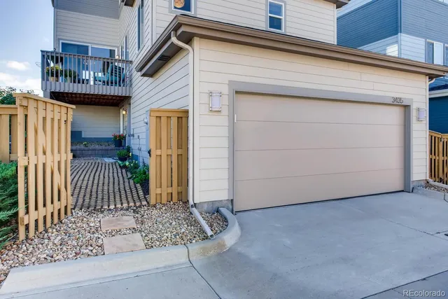 a view of a house with a door and wooden bench