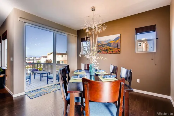 a dining room with furniture window and wooden floor
