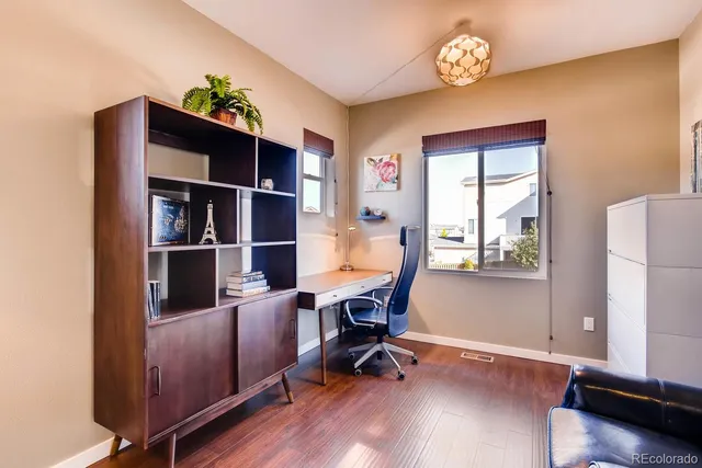 a view of a workspace with furniture and a window