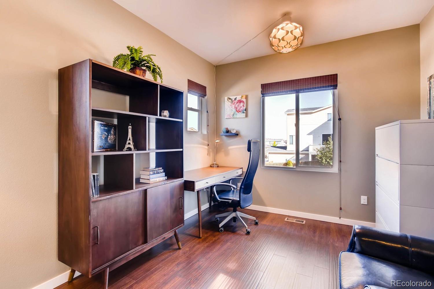 3435 Cranston Circle Highlands Ranch, CO 80126 - Photo 9 of 40 a view of a workspace with furniture and a window