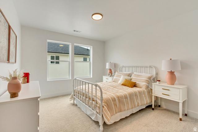 1389 1440 East, Unit 1 Payson, UT 84651 - Photo 12 of 17 Bedroom featuring two large windows, neutral carpeting, and a flush-mount ceiling light fixture