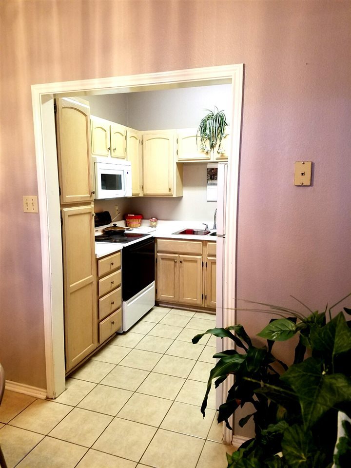 1207 Hillside Road, Unit 10 Laredo, TX 78041 - Photo 4 of 7 a kitchen with a sink a stove cabinets and a window