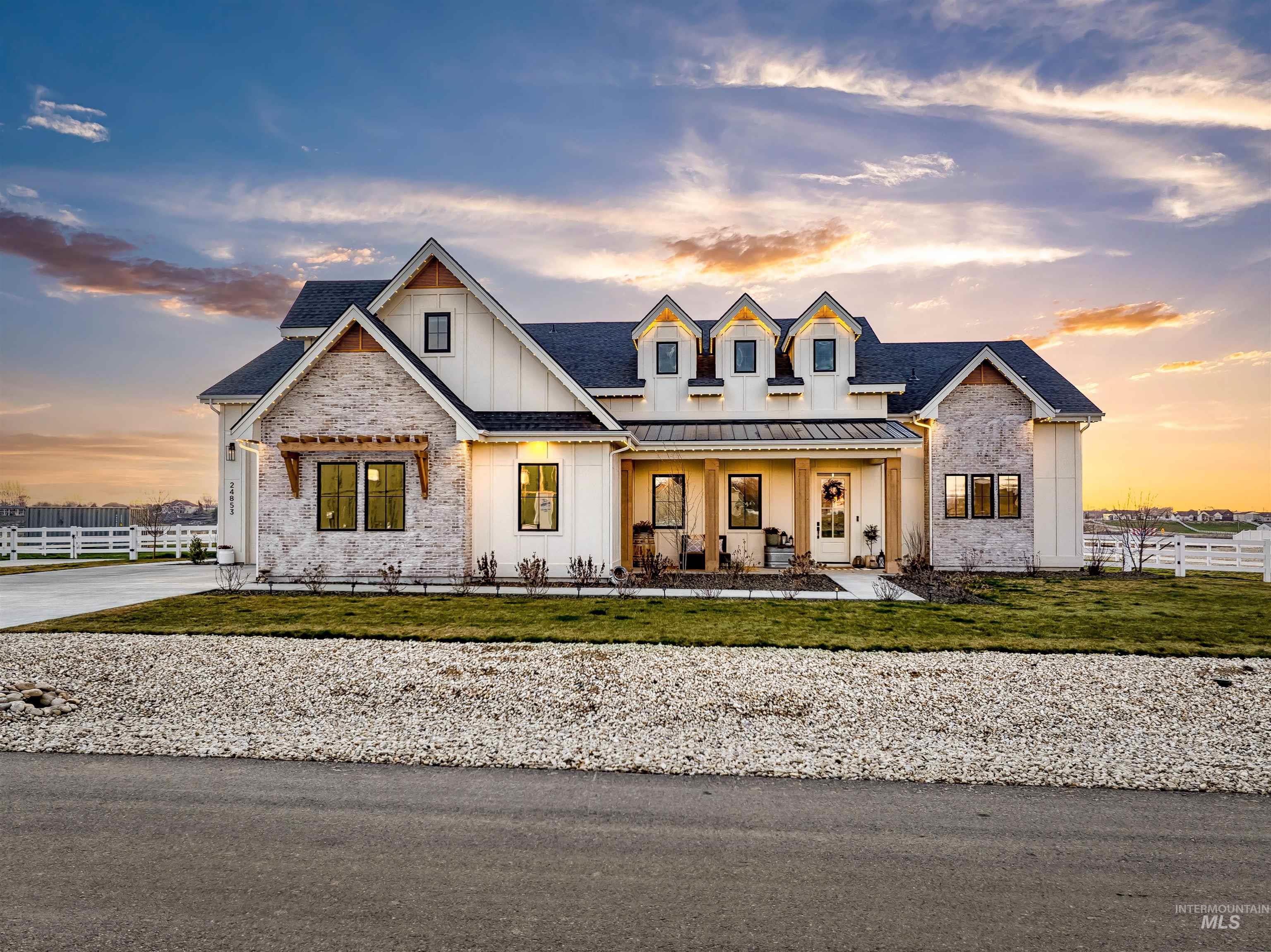 Modern farmhouse style home featuring board and batten siding, a porch, and a standing seam roof
