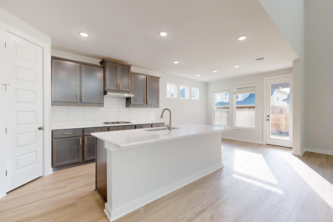 2029 Billings Way Leander, TX 78641 - Photo 2 of 29 a kitchen with kitchen island a sink stainless steel appliances and cabinets