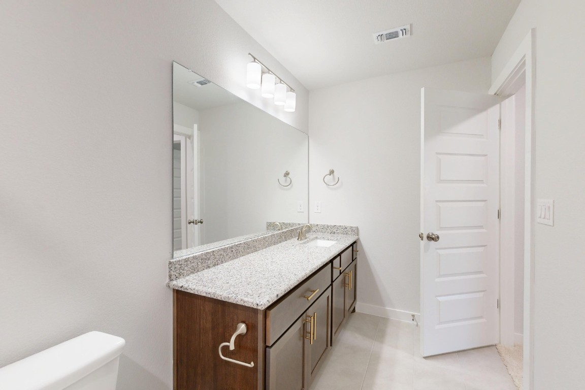 2029 Billings Way Leander, TX 78641 - Photo 22 of 29 a bathroom with a granite countertop sink and a mirror