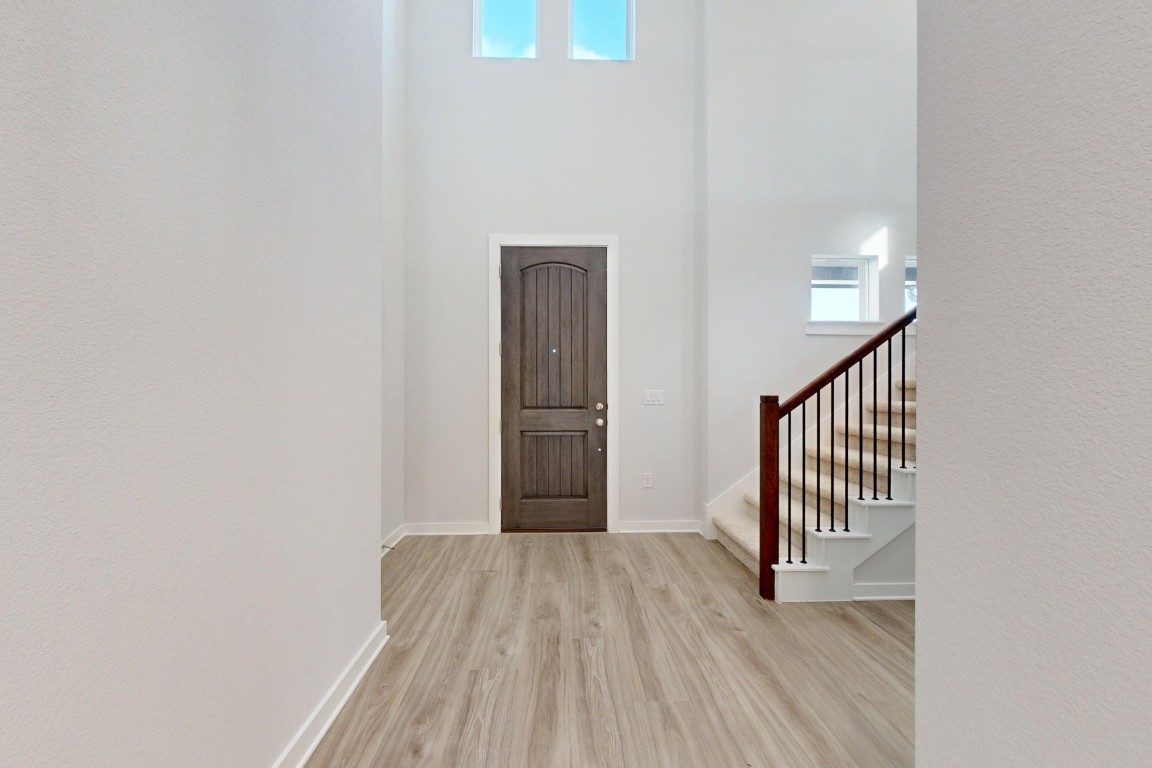 2029 Billings Way Leander, TX 78641 - Photo 8 of 29 a view of a hallway with wooden floor and staircase
