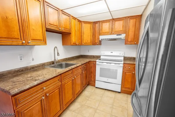 a kitchen with stainless steel appliances granite countertop a sink and a stove