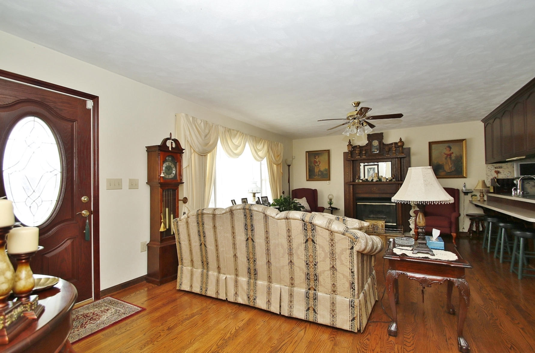 1883 Mill Iron Road Goodview, VA 24095 - Photo 3 of 56 a living room with furniture a fireplace and a flat screen tv