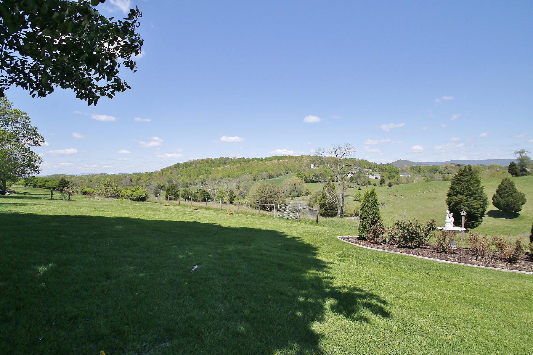 1883 Mill Iron Road Goodview, VA 24095 - Photo 48 of 56 a view of a lush green outdoor space with a swimming pool and mountain view