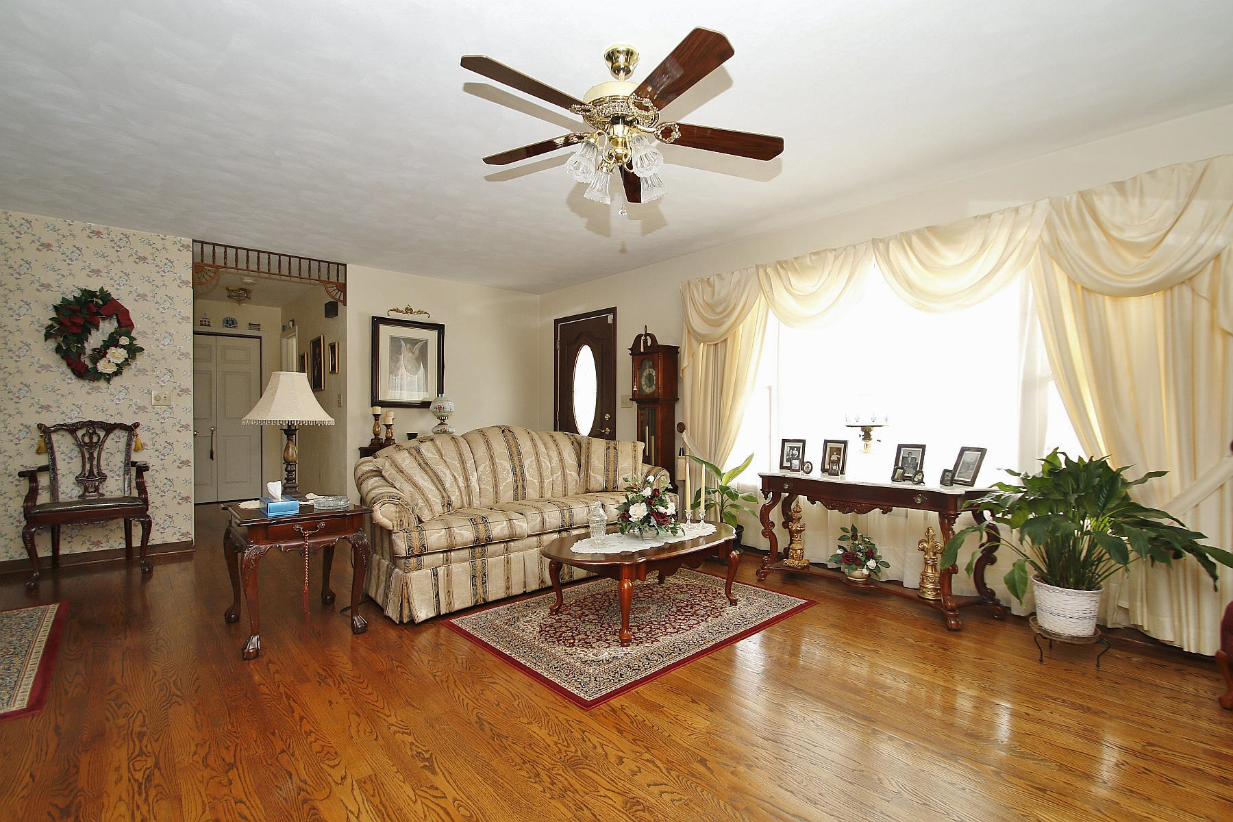 1883 Mill Iron Road Goodview, VA 24095 - Photo 6 of 56 a living room with furniture ceiling fan and a large window