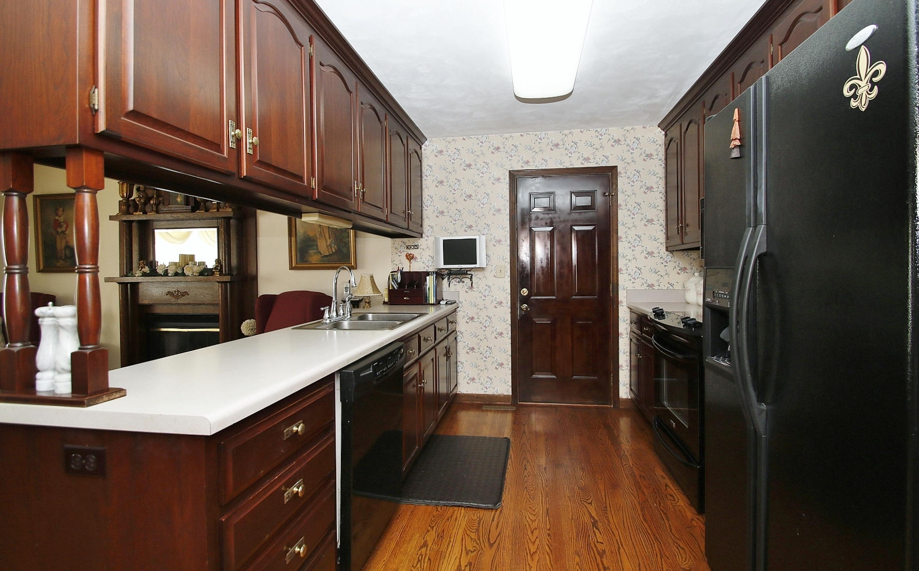1883 Mill Iron Road Goodview, VA 24095 - Photo 10 of 56 a kitchen with stainless steel appliances granite countertop a refrigerator a sink dishwasher and wooden cabinets with wooden floor
