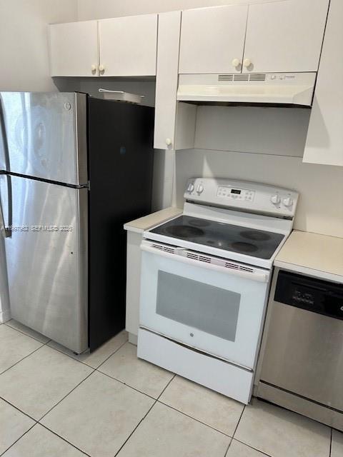 a stove top oven sitting inside of a kitchen