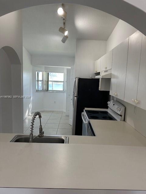 2931 Southeast 12th Road, Unit 20355 Homestead, FL 33035 - Photo 9 of 10 a kitchen with a refrigerator and a sink