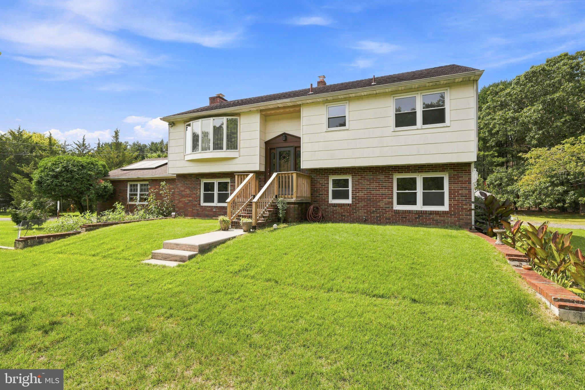 Charming split-level home on lush grounds.