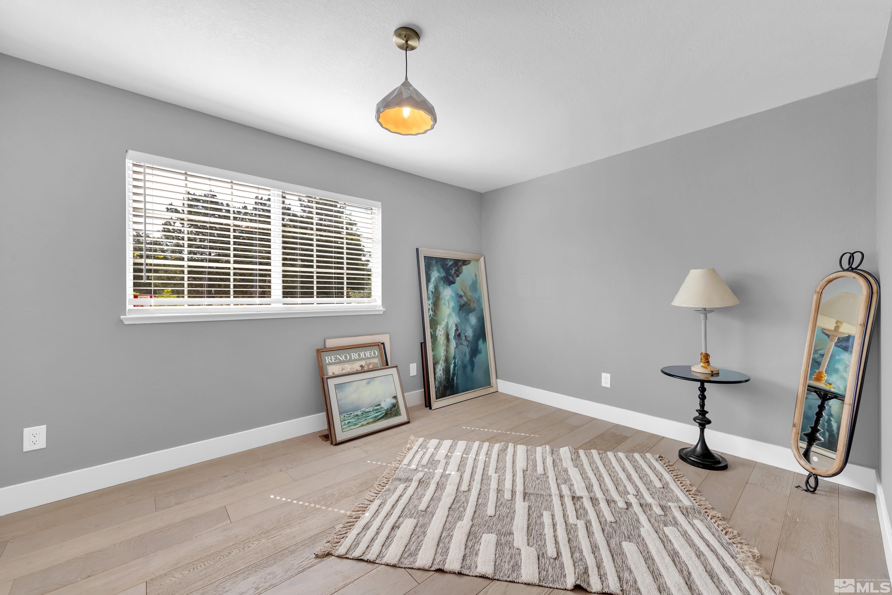 962 University Ridge Court Reno, NV 89512 - Photo 14 of 40 a bedroom with a bed and a lamp