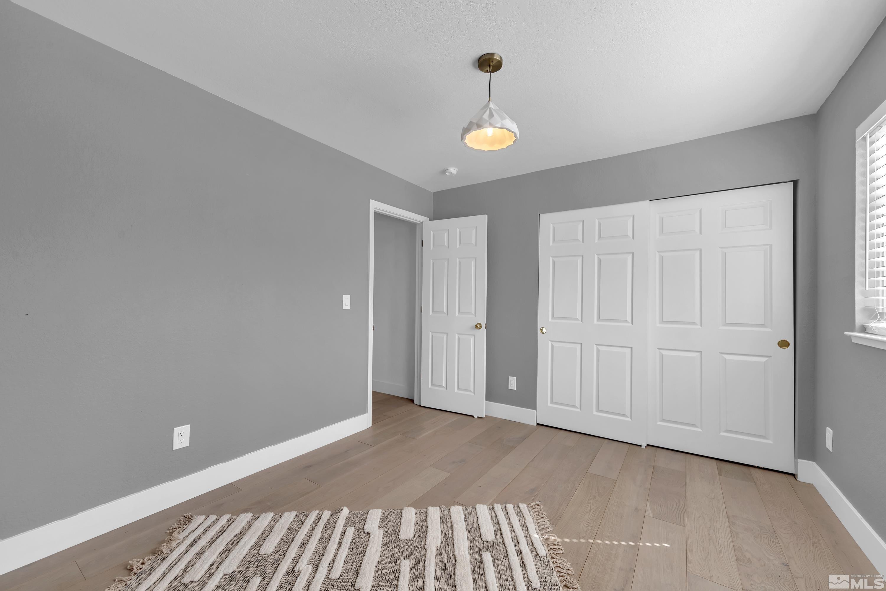 962 University Ridge Court Reno, NV 89512 - Photo 15 of 40 a view of an empty room and wooden floor