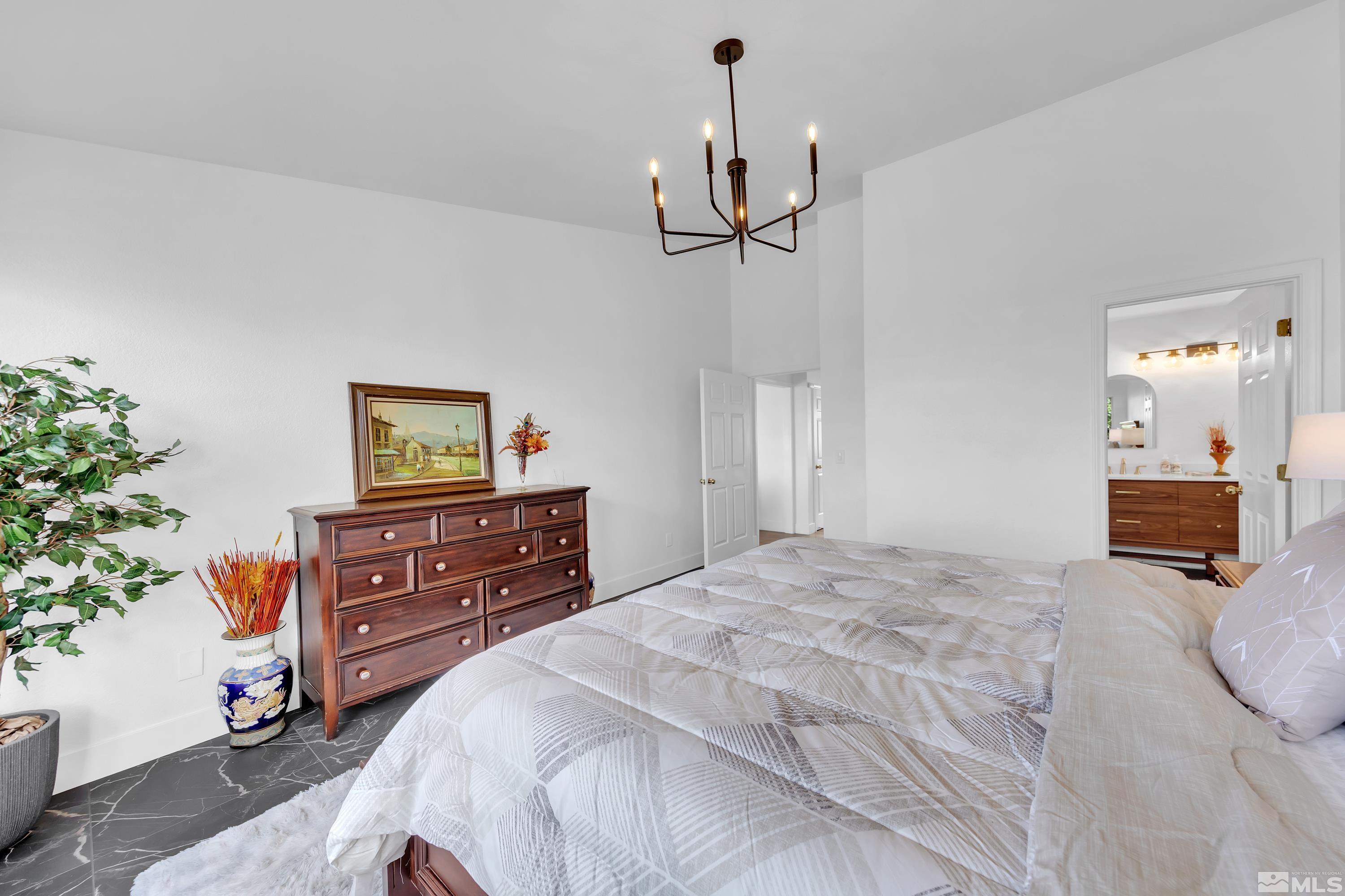 962 University Ridge Court Reno, NV 89512 - Photo 29 of 40 a bedroom with a bed and a dresser in it