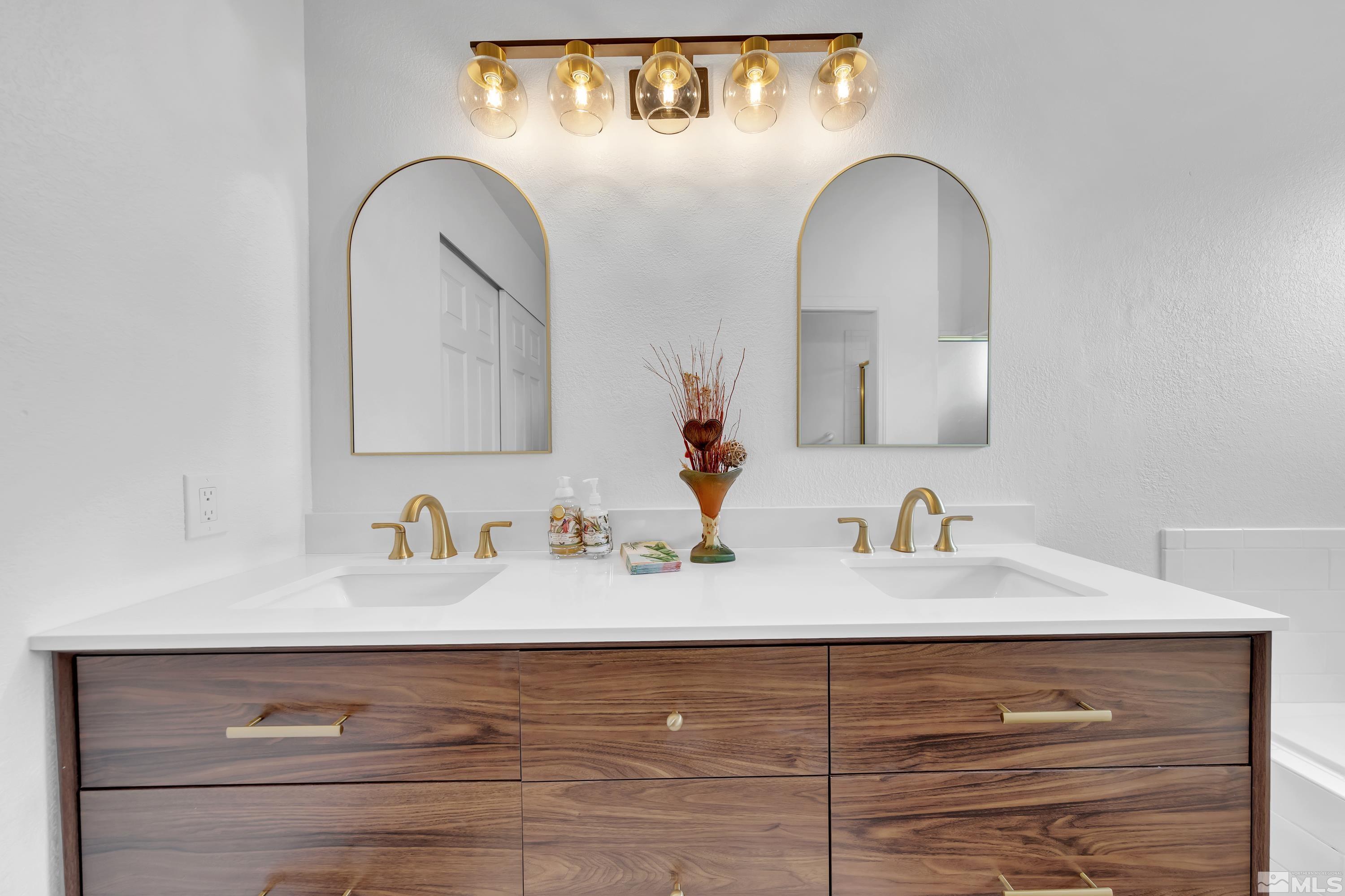 962 University Ridge Court Reno, NV 89512 - Photo 30 of 40 a bathroom with a double vanity sink and a mirror