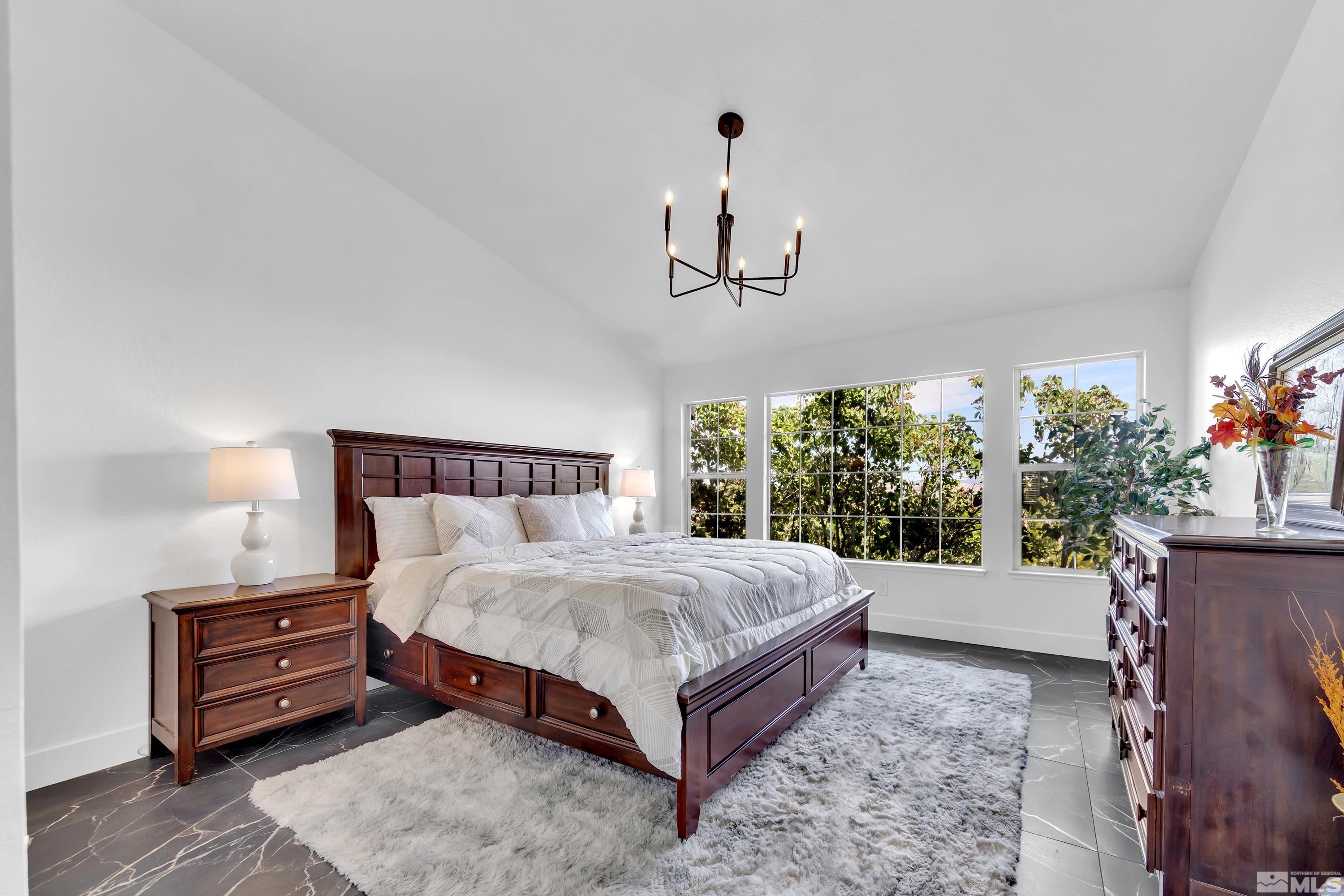 962 University Ridge Court Reno, NV 89512 - Photo 9 of 40 a bed sitting in a spacious bedroom next to a window