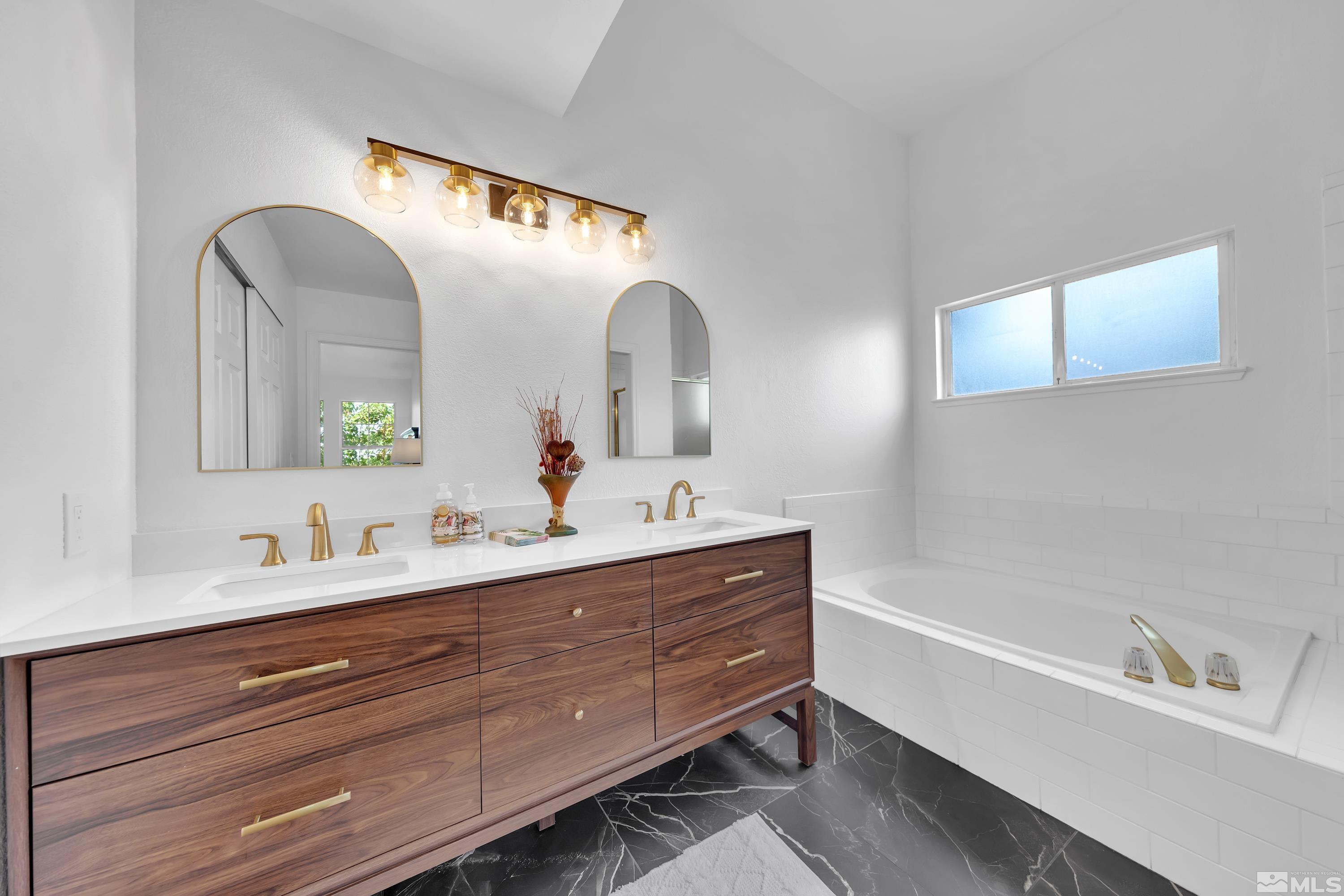 962 University Ridge Court Reno, NV 89512 - Photo 10 of 40 a bathroom with a double vanity sink and a mirror