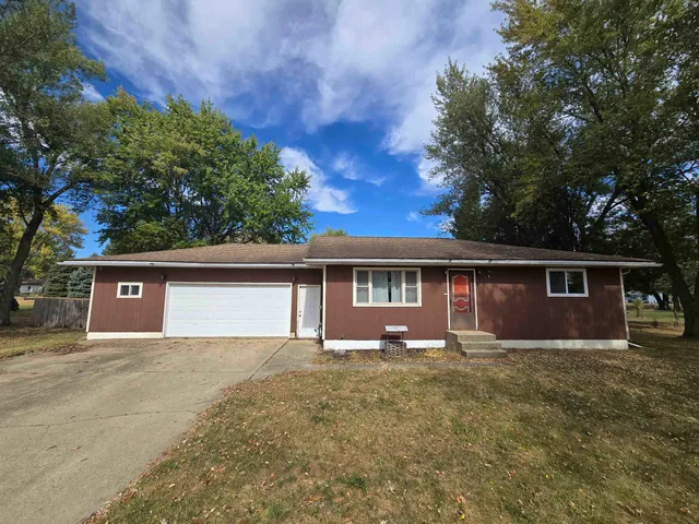 a front view of a house with a yard and a garage
