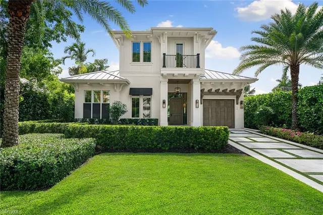 a front view of a house with a garden