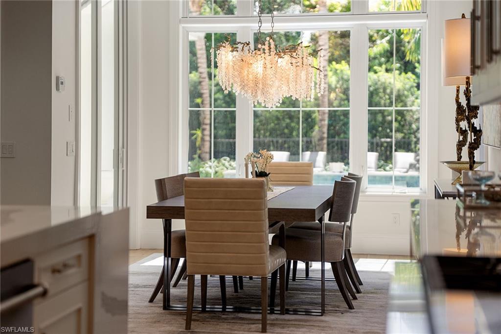 150 6th Street North Naples, FL 34102 - Photo 13 of 46 a dining room with furniture and wooden floor