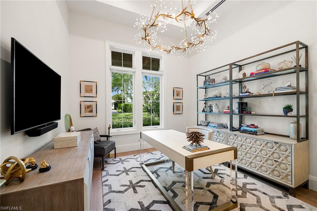 150 6th Street North Naples, FL 34102 - Photo 14 of 46 a living room with patio furniture and a flat screen tv