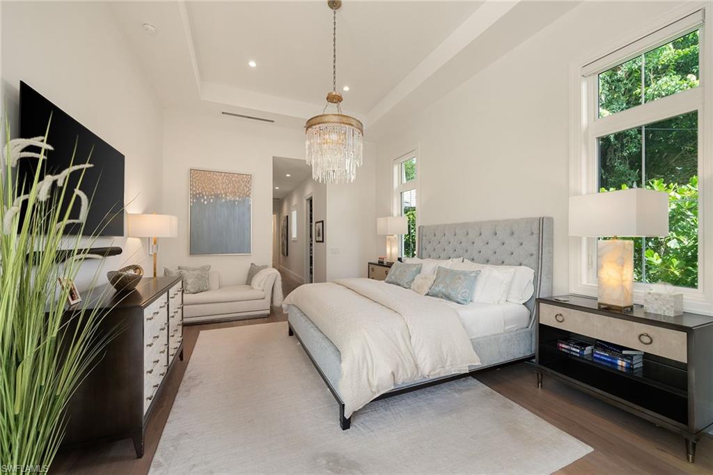 150 6th Street North Naples, FL 34102 - Photo 16 of 46 a spacious bedroom with a bed couch and a window