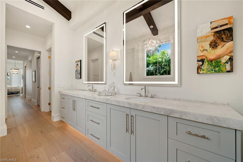 150 6th Street North Naples, FL 34102 - Photo 18 of 46 a bathroom with a granite countertop sink mirror and vanity