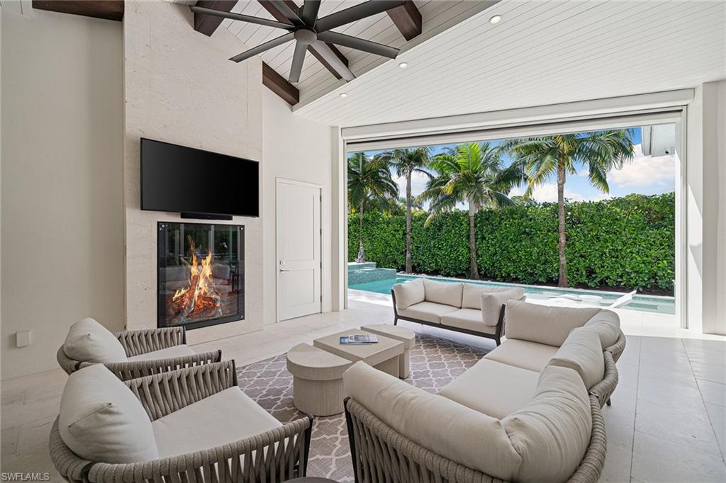 150 6th Street North Naples, FL 34102 - Photo 21 of 46 a living room with furniture and a large window