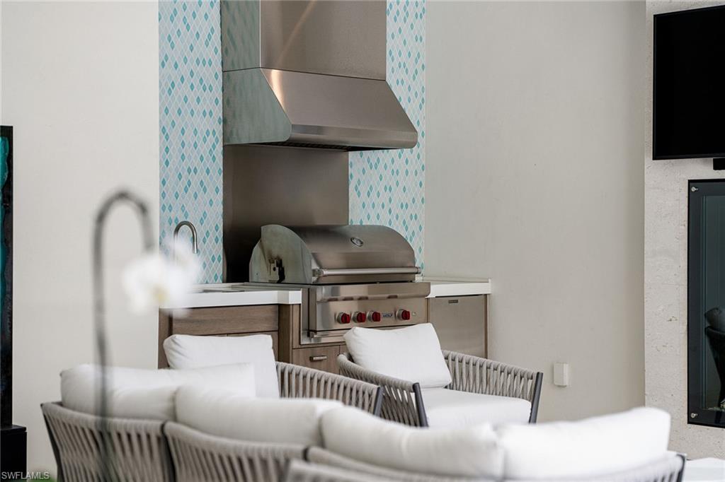 150 6th Street North Naples, FL 34102 - Photo 23 of 46 a living room with furniture and a flat screen tv