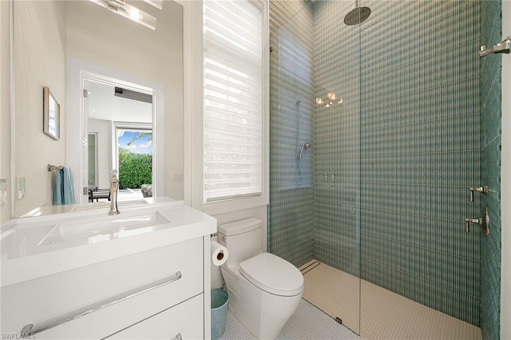 150 6th Street North Naples, FL 34102 - Photo 24 of 46 a bathroom with a sink a toilet and shower