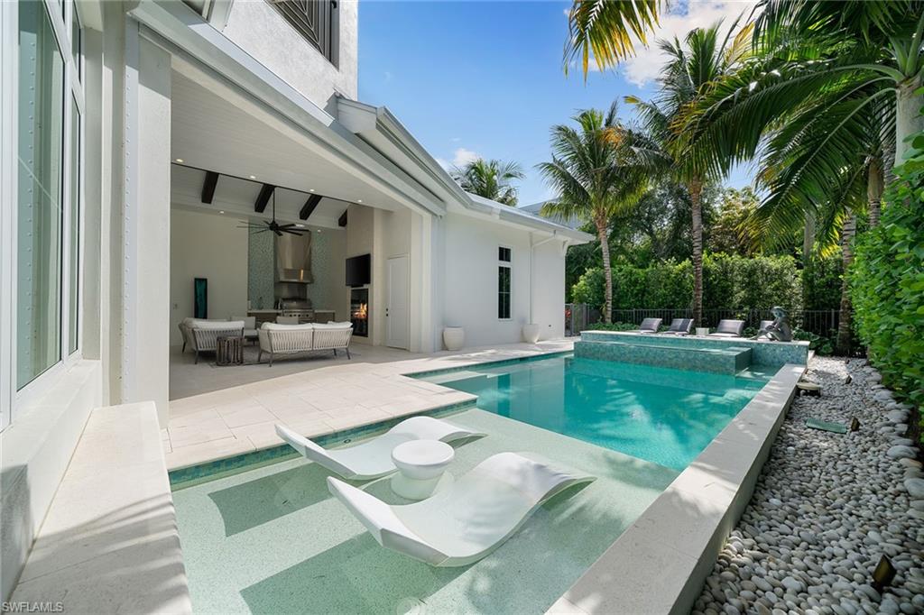 150 6th Street North Naples, FL 34102 - Photo 25 of 46 a view of a house with backyard porch and sitting area