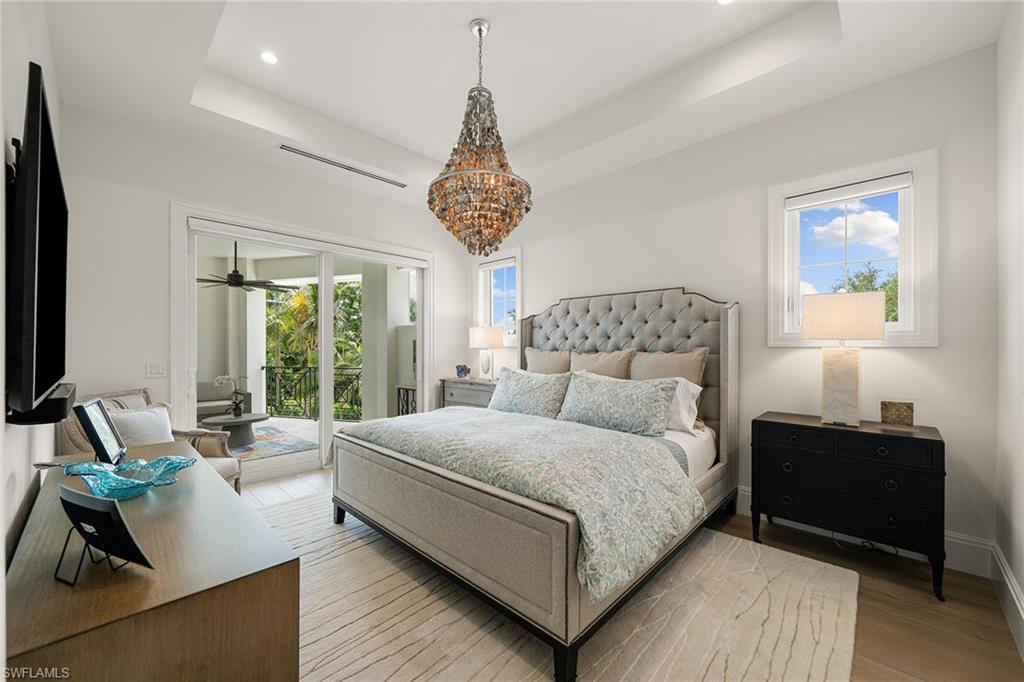 150 6th Street North Naples, FL 34102 - Photo 32 of 46 a bedroom with a large bed and a couch