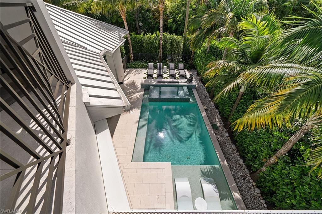 150 6th Street North Naples, FL 34102 - Photo 35 of 46 a view of yard with swimming pool and outdoor seating