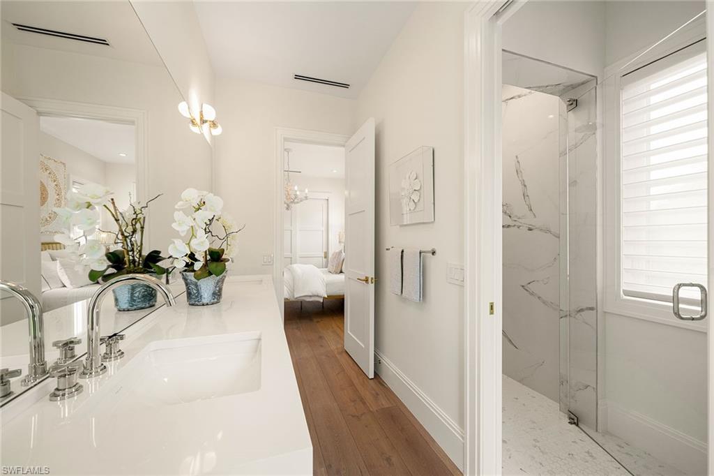 150 6th Street North Naples, FL 34102 - Photo 38 of 46 a hallway with a chandelier and a couch