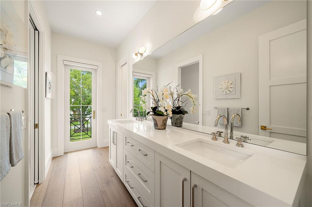 150 6th Street North Naples, FL 34102 - Photo 39 of 46 a bathroom with a double vanity sink mirror and next to a window
