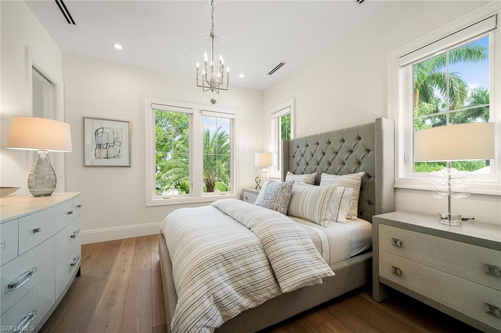 150 6th Street North Naples, FL 34102 - Photo 40 of 46 a bedroom with a large bed and a window