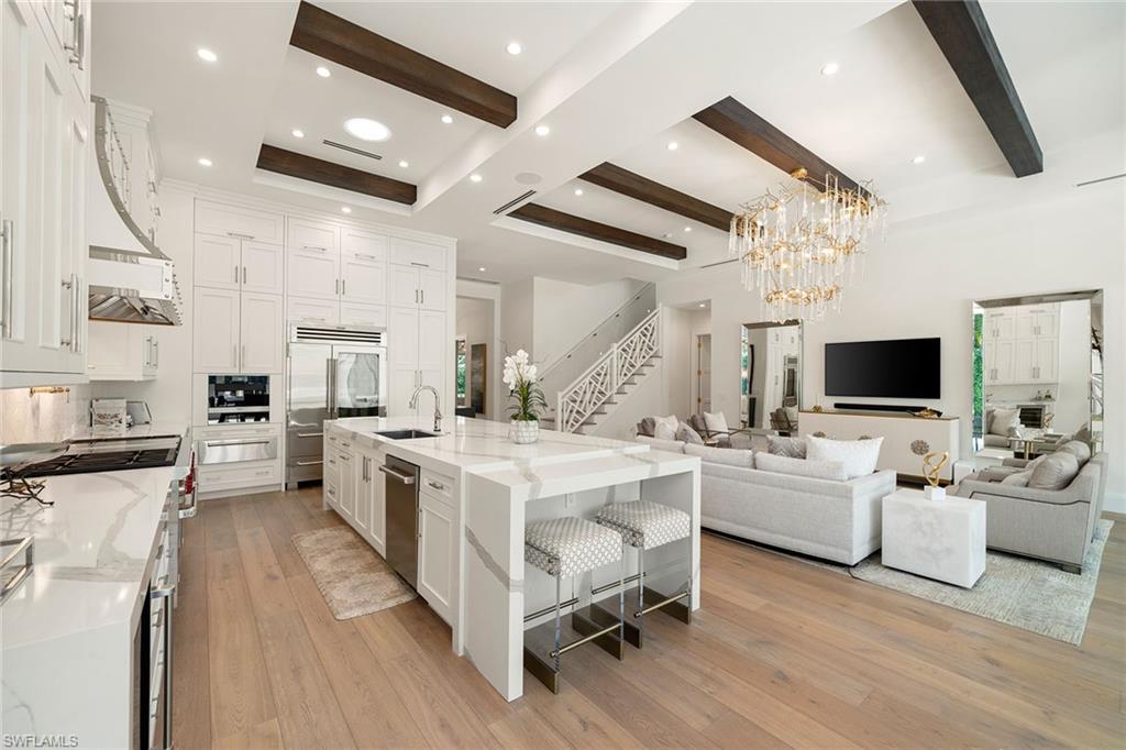 150 6th Street North Naples, FL 34102 - Photo 9 of 46 a kitchen with a sink appliances and cabinets