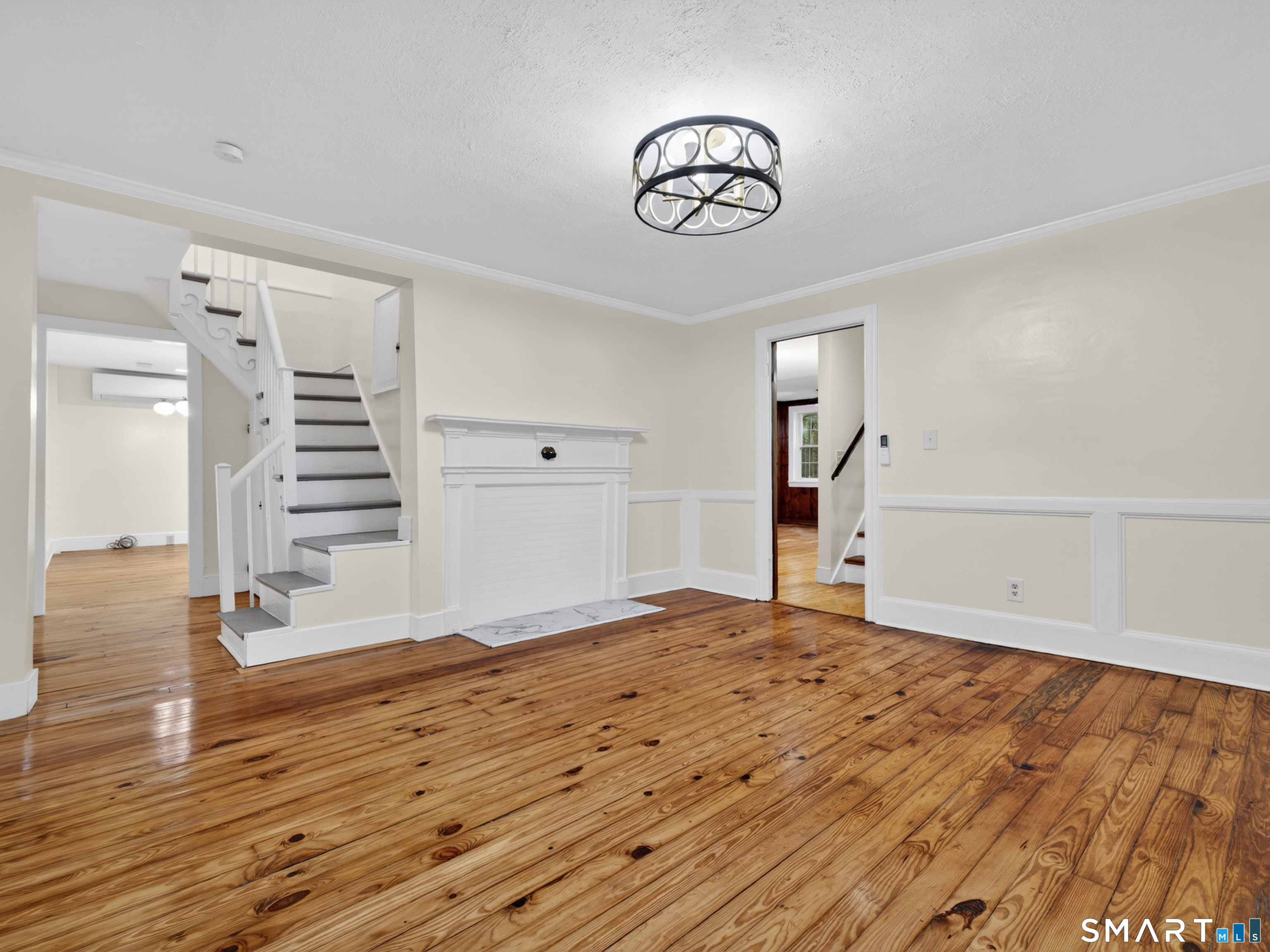 380 Main Street Meriden, CT 06451 - Photo 14 of 40 a view of a livingroom with wooden floor and stairs