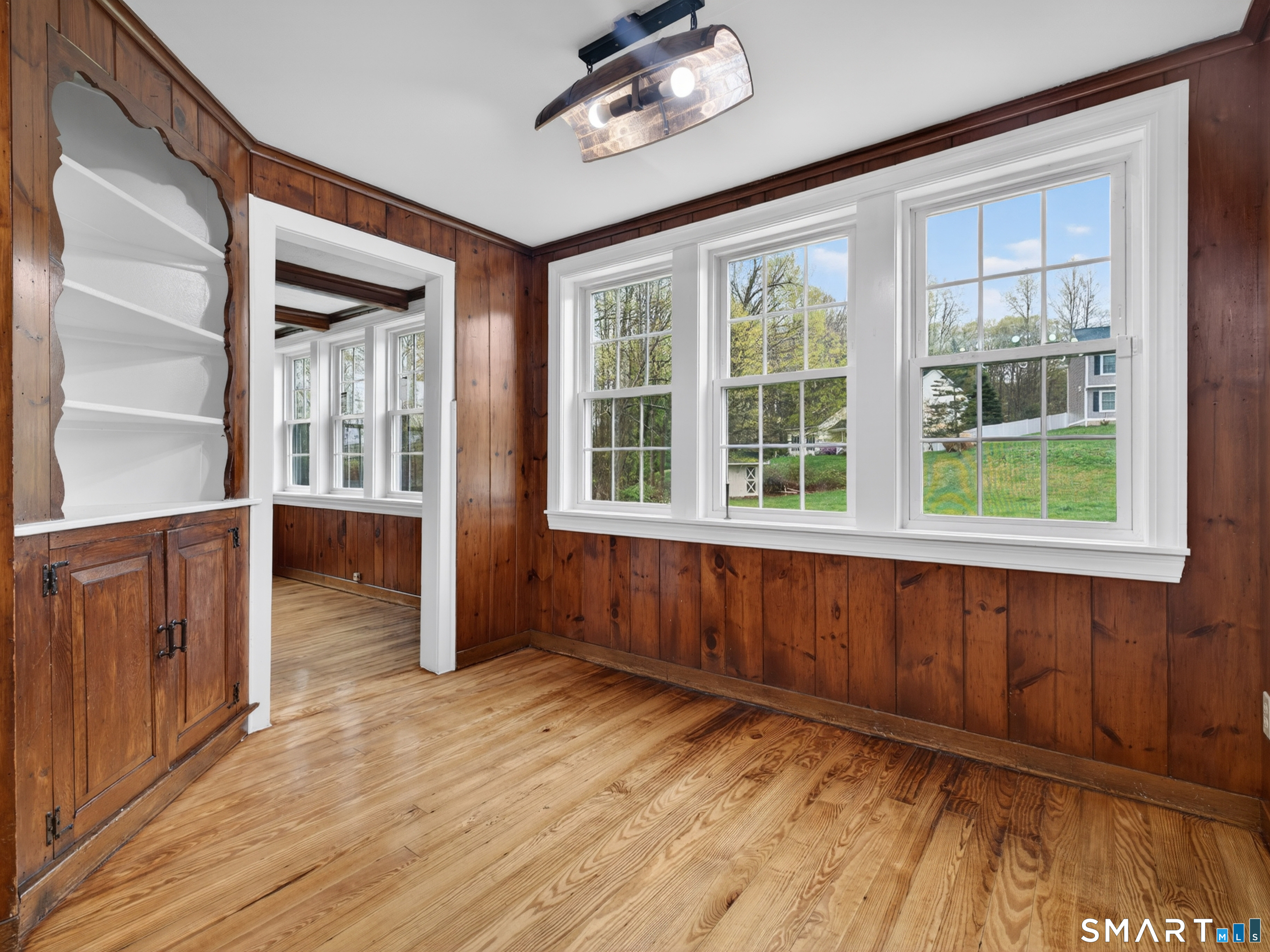 380 Main Street Meriden, CT 06451 - Photo 16 of 40 a view of an empty room with wooden floor and a window