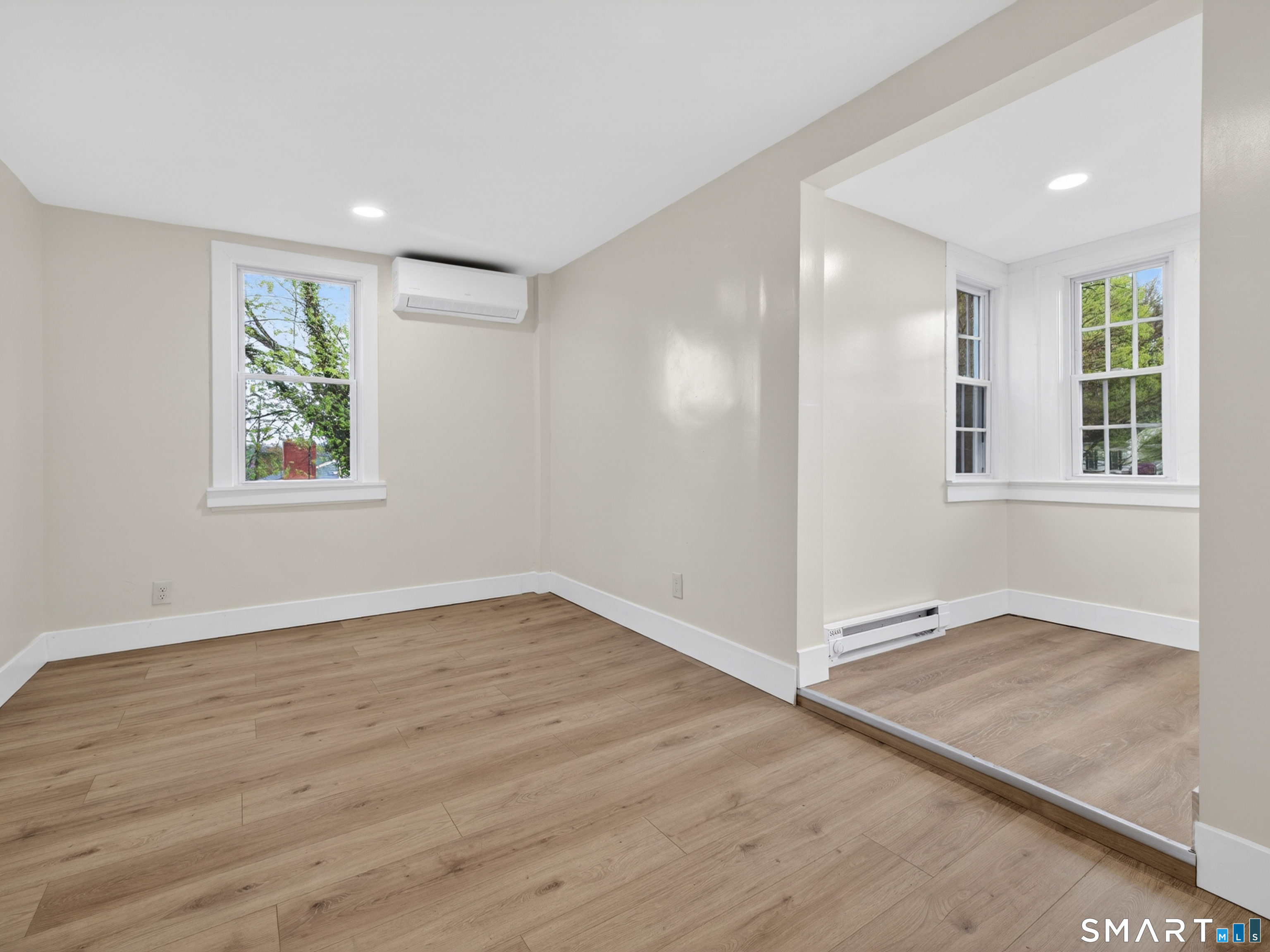 380 Main Street Meriden, CT 06451 - Photo 22 of 40 an empty room with wooden floor and windows